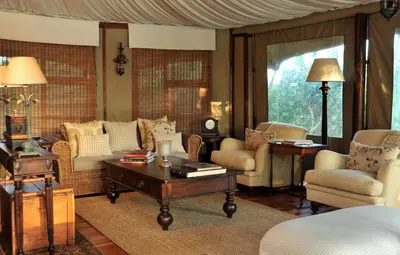 a living room with a couch and a table at Hamiltons Tented Camp in Mluwati Concession