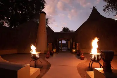 a building with two fires in front of it at Hoyo Hoyo Safari Lodge in Mluwati Concession