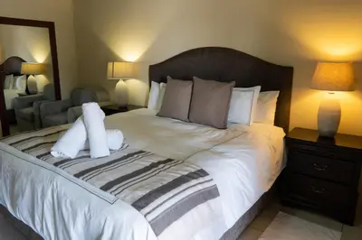 a bedroom with a bed with two stuffed animals on it at Fumani Game Lodge in Modimolle