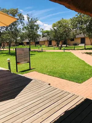 a park with a sign in the grass at Fumani Game Lodge in Modimolle
