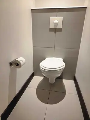 a bathroom with a white toilet in a stall at SUN1 MIDRAND in Midrand
