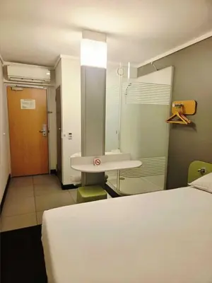 a room with a bed and a sink and a bathroom at SUN1 MIDRAND in Midrand