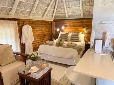 a bedroom with a bed and a couch in a room at iKhaya LamaDube Game Lodge in Klipdrift