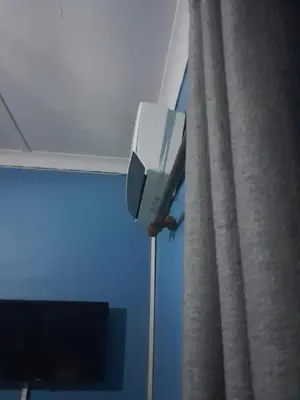 a security camera on the side of a room with a curtain at Paul & Mollie's Guest House in Brits