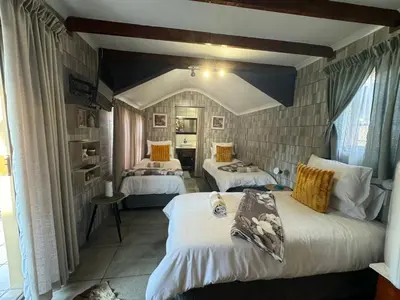 a bedroom with two beds in a room at Paul & Mollie's Guest House in Brits