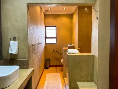 a bathroom with a sink and a toilet and a shower at Telestai Guest House in White River