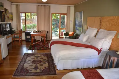 a bedroom with a bed and a living room at Bed & Breakfast in Hatfield in Pretoria