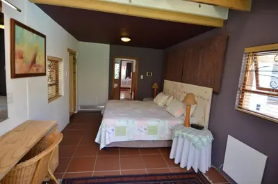 a bedroom with a bed and a table at Bed & Breakfast in Hatfield in Pretoria