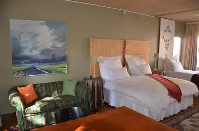 a bedroom with a bed and a couch and a chair at Bed & Breakfast in Hatfield in Pretoria