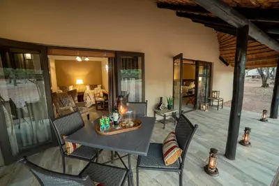 a room with a table and chairs on a patio at Mabula Game Lodge in Mabula