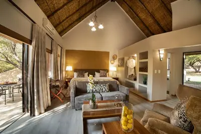 a living room with a bed and a couch at Mabula Game Lodge in Mabula