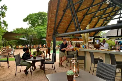 a group of people sitting at tables on a patio at Mabula Game Lodge in Mabula