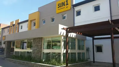 a building with a sun sign on the side of it at SUN1 PRETORIA in Pretoria