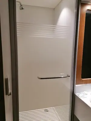 a glass shower door in a small bathroom at SUN1 PRETORIA in Pretoria
