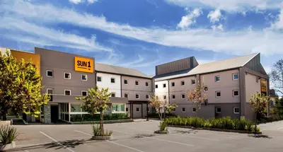 a building with a sun sign on the side of it at SUN1 PRETORIA in Pretoria