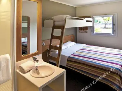 a small bedroom with a bunk bed and a sink at SUN1 PRETORIA in Pretoria