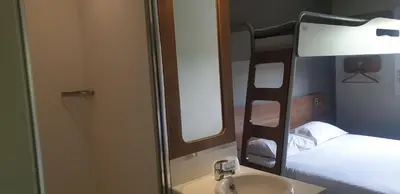 a bathroom with a bunk bed and a sink and a mirror at SUN1 BENONI in Benoni