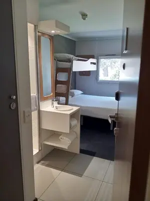 a bathroom with a sink and a bunk bed at SUN1 BENONI in Benoni