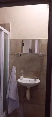 a bathroom with a sink and a mirror at 13 @ Rhinoroad Nelspruit in Nelspruit