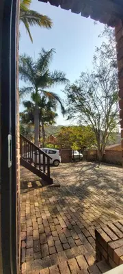 a door of a house with a car parked in a driveway at 13 @ Rhinoroad Nelspruit in Nelspruit