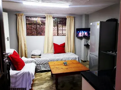 a living room with a couch and a table at 13 @ Rhinoroad Nelspruit in Nelspruit