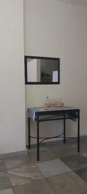 a table in a room with a mirror on the wall at 13 @ Rhinoroad Nelspruit in Nelspruit