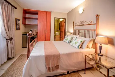 a bedroom with a large white bed in a room at La Kruger Lifestyle Lodge - No Loadshedding in Marloth Park