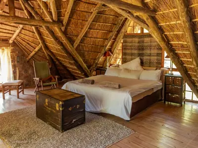 a bedroom with a large bed in a attic at KwaThabisile Bush Retreat in Cullinan