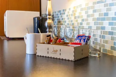 a box sitting on top of a counter with cups at Pumleni Guesthouse in Hartbeespoort