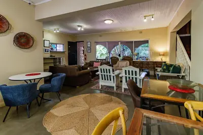 a living room with a couch and a table at Pumleni Guesthouse in Hartbeespoort