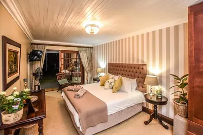 a hotel room with a bed and a television at The Aloes in Nelspruit