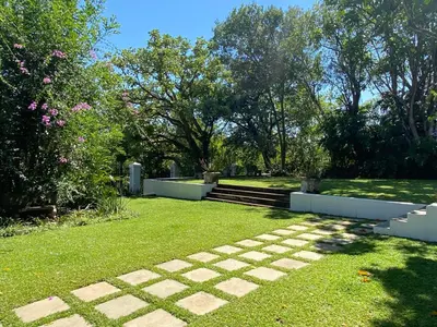 a garden with a stone path in the grass at The Aloes in Nelspruit