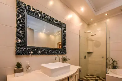 a bathroom with a sink and a mirror at The Aloes in Nelspruit