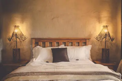 a bedroom with a bed with two lamps on it at Grincourt B&B- with No Load shedding in Polokwane
