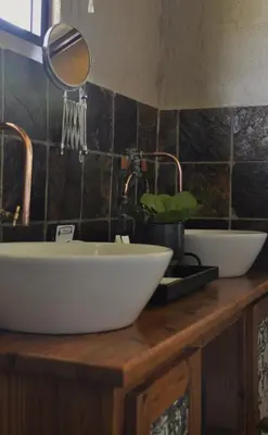 a bathroom counter with two sinks and a mirror at Grincourt B&B- with No Load shedding in Polokwane