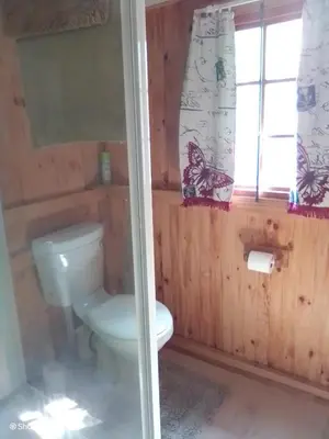a bathroom with a toilet and a window at Pumba's Lookout in Barberton