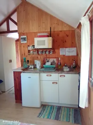 a kitchen with white cabinets and a microwave at Pumba's Lookout in Barberton