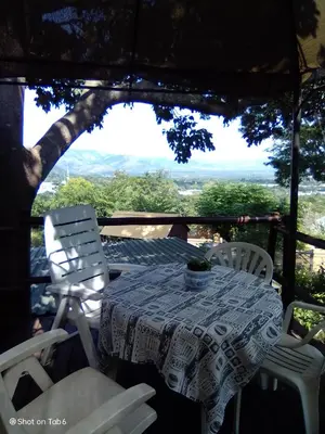 a table and chairs on a porch with a view at Pumba's Lookout in Barberton