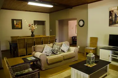 a living room with a couch and a table at Mountain Creek Lodge in Hazyview