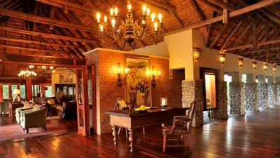 a large room with a table and a chandelier at Imbali Safari Lodge in Mluwati Concession