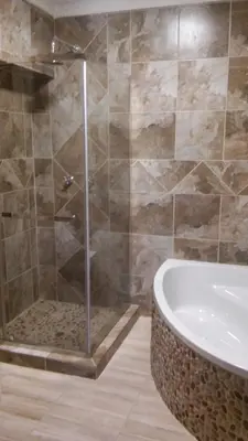 a bathroom with a shower and a bath tub at hanna's place in Polokwane