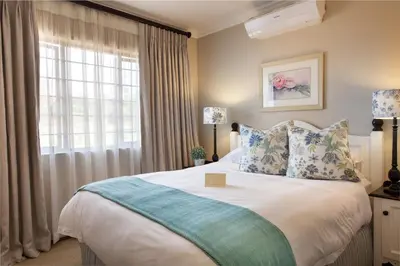 a bedroom with a large bed with a window at Oliver`s in White River