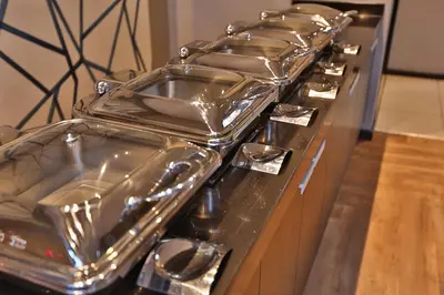 a row of pans sitting on top of a stove at Inani Hotel Morning Star in Pretoria