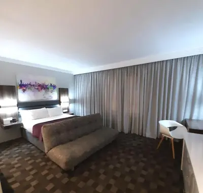 a hotel room with a bed and a couch at Palm Swift Luxury Accommodation in Brits