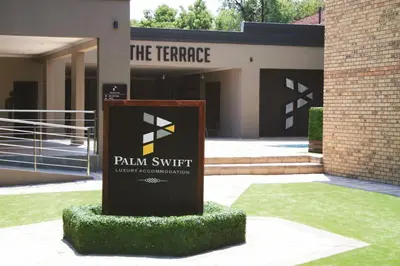 a sign in front of a building at Palm Swift Luxury Accommodation in Brits