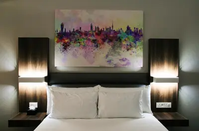 a bedroom with a bed with a painting above it at Palm Swift Luxury Accommodation in Brits