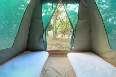 a tent with a window and a mattress in it at Kruger Adventure Lodge in Hazyview