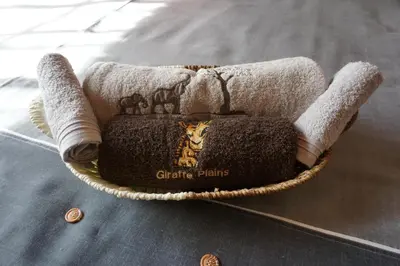a basket with two towels on a table at Giraffe plains in Marloth Park