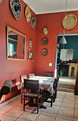 a dining room with a table and chairs at Old Vic Travellers Inn Nelspruit in Nelspruit