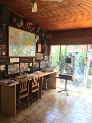 a room with a table and chairs and a map on the wall at Old Vic Travellers Inn Nelspruit in Nelspruit